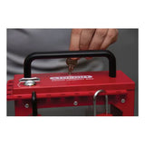 A person inserts a key into an Accuform STOPOUT Pry-Resistant Lock Box KCC690 by AccuformNMC while holding its handle. This rust-resistant lock box is engineered for safety lockout procedures and includes multiple slots to protect against electrical hazards.