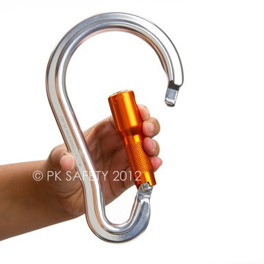 A hand holds the Skylotec Large Aluminum Carabiner 2 in. Gate Opening BIG AL TW H-151, featuring a twist-lock gate and an orange accent. The text "© PK Safety 2012" is visible on the image, underscoring its reliability in fall protection scenarios.