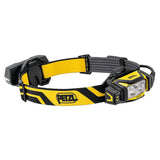 The Petzl XENA Rechargeable Headlamp E004BA00, designed in yellow and black, is ideal for industrial professionals. It features two LED lights, a rear battery pack, and an adjustable strap to offer hands-free illumination for tasks such as hiking or repairs.