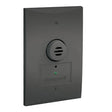 A black Vulcain Honeywell Analytics E3Point  Remote Sensor with a round vented section and green indicator light, installed on a white wall as a gas detection device.