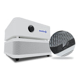 The Austin Air "it" Machine C100 by Austin Air Systems is a white, compact air purifier with a black control knob and black feet; a circular inset highlights its honeycomb filter and foam lining for efficient filtration of airborne particles.