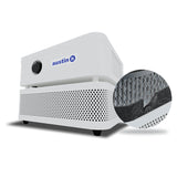 The Austin Air Systems "it" Machine C100 is a compact white air purifier with a black control knob and perforated grille; its honeycomb filter efficiently removes airborne particles.