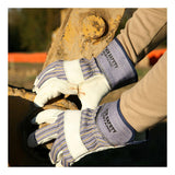 Wearing MCR Safety's Mustang Grain Leather Palm Gloves 1935, a person grips a large rusted metal part while operating heavy outdoor machinery.