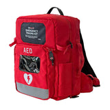 The Aero Healthcare Modulator Trauma Backpack M600B is a red, ANSI Class B First Aid Kit with a clear "AED" window, heart and lightning bolt symbol, reflective strips, and shoulder straps—essential for emergencies.