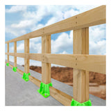 A wooden safety guardrail, supported by Frontline Fall Protection’s Frontline Safety Guardrail Boot Base w/Hardware GPB200 units, is installed along a concrete edge under a blue sky and clouds for effective perimeter protection.