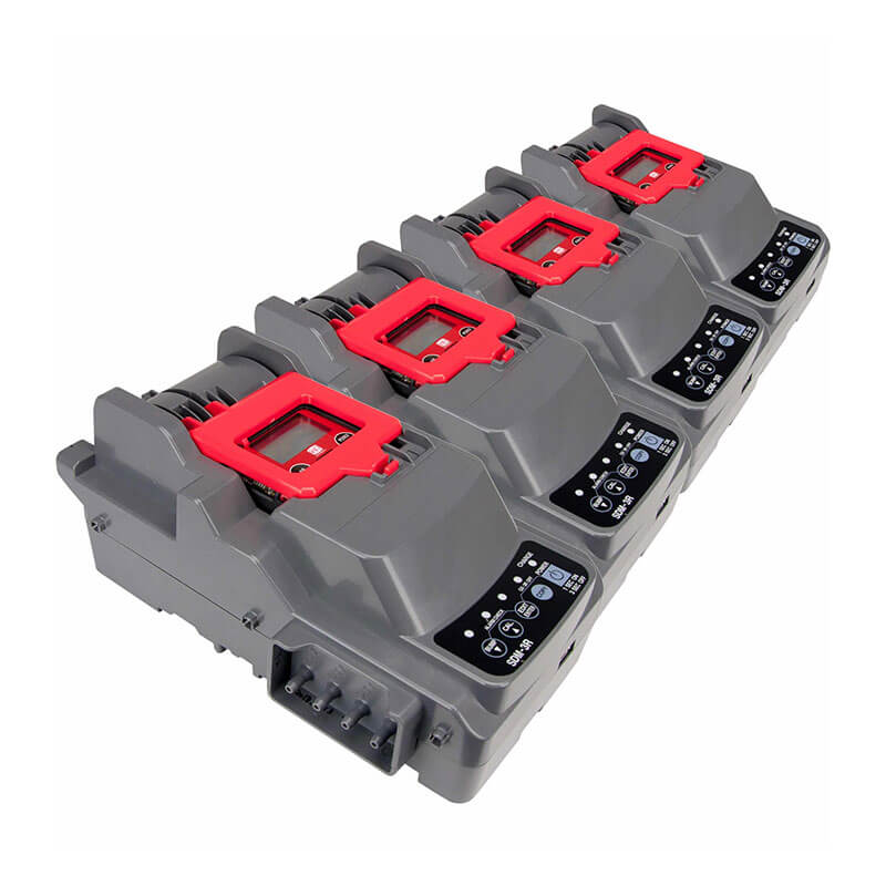 The RKI Instruments SDM-3R Stand Alone Calibration Station (81-SDM3R101) is a compact gray four-slot device with black and red accents, control buttons, and indicator lights on each slot, shown angled on a white background.