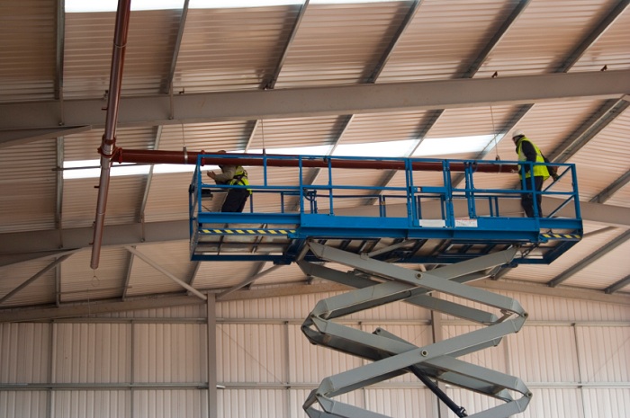 Do workers need additional fall protection on scissor lifts and other aerial devices?