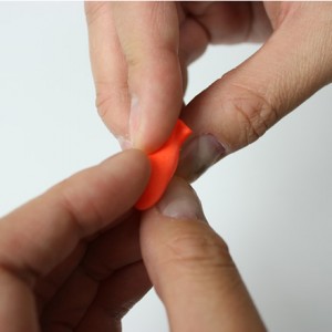 By squeezing the foam ear plug it fits into the ear canal more easily